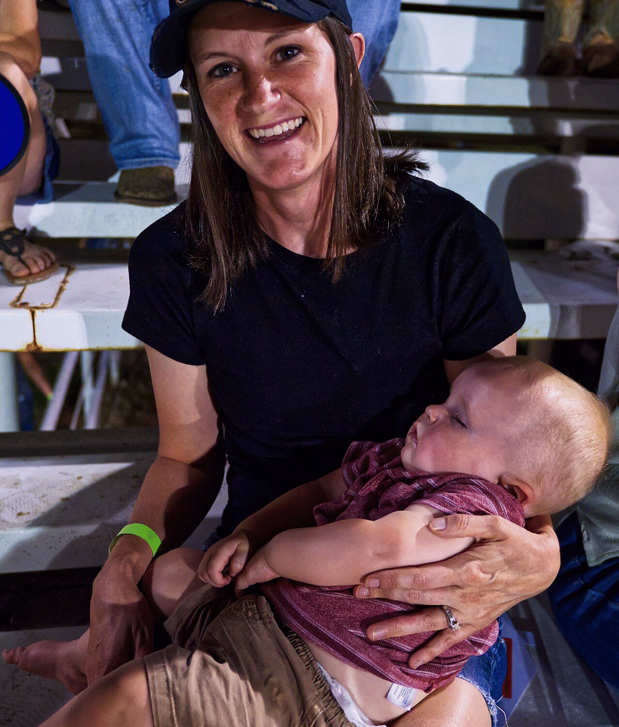 Alisha Robison holds a napping Don Robison during his first rodeo Friday night. [see more sights and MFDR 2023 rodeo action]